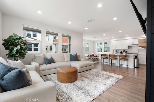146 Fable, Irvine, CA 92618 - living room with light wood-style flooring and recessed lighting