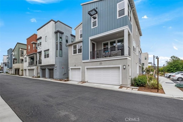 146 Fable, Irvine, CA 92618 - view of front facade featuring board and batten siding, an attached garage, a balcony, and a residential view
