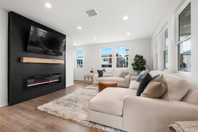 146 Fable, Irvine, CA 92618 - living area with recessed lighting, wood finished floors, a large fireplace, and baseboards
