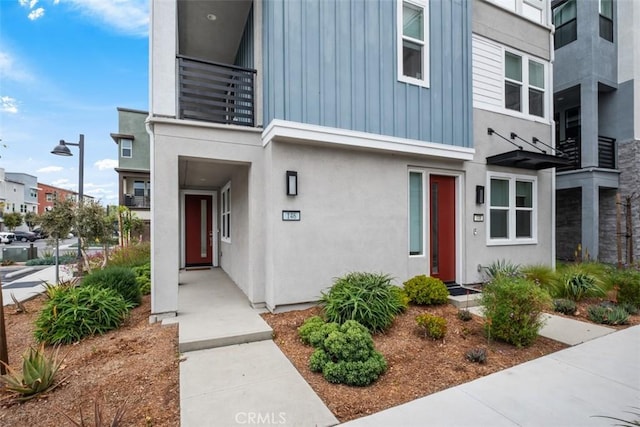 146 Fable, Irvine, CA 92618 - property entrance featuring stucco siding, board and batten siding, and a balcony