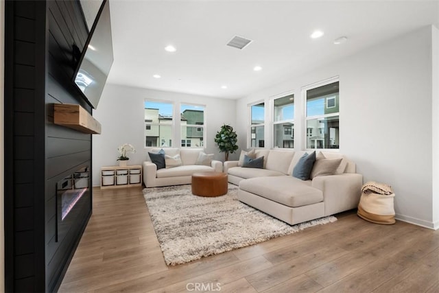 146 Fable, Irvine, CA 92618 - living room featuring a large fireplace, light wood-type flooring, recessed lighting, and baseboards