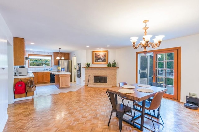 22437 Haynes St, West Hills, CA 91307 - dining space featuring baseboards, a brick fireplace, a chandelier, and recessed lighting