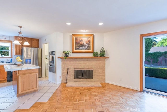 22437 Haynes St, West Hills, CA 91307 - kitchen with appliances with stainless steel finishes, a healthy amount of sunlight, tile countertops, and a warming drawer