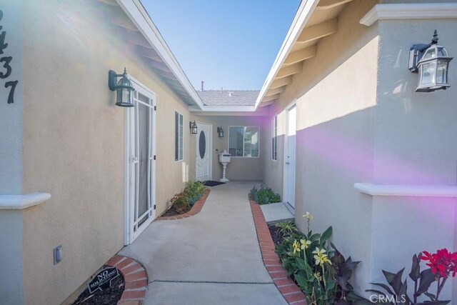 22437 Haynes St, West Hills, CA 91307 - view of side of home featuring a patio area and stucco siding