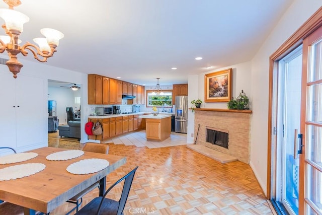 22437 Haynes St, West Hills, CA 91307 - dining room with baseboards, a fireplace, ceiling fan with notable chandelier, and recessed lighting