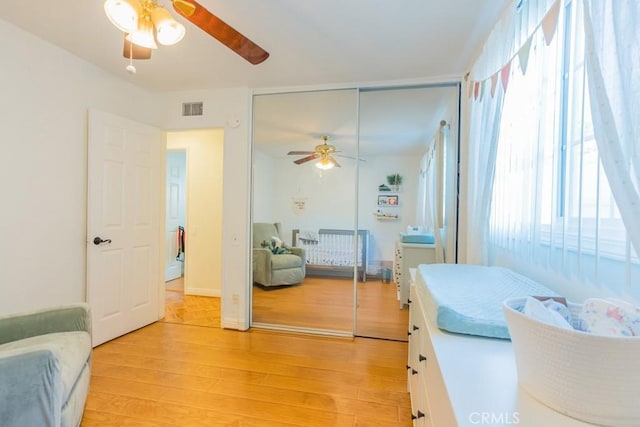 22437 Haynes St, West Hills, CA 91307 - bedroom with a closet, visible vents, light wood-style flooring, and a ceiling fan