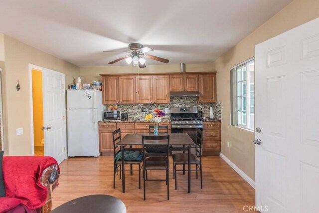 22437 Haynes St, West Hills, CA 91307 - kitchen featuring stainless steel appliances, tasteful backsplash, brown cabinetry, ceiling fan, and light wood finished floors
