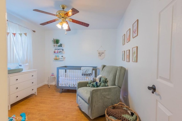 22437 Haynes St, West Hills, CA 91307 - bedroom with a nursery area, light wood-style floors, baseboards, and a ceiling fan