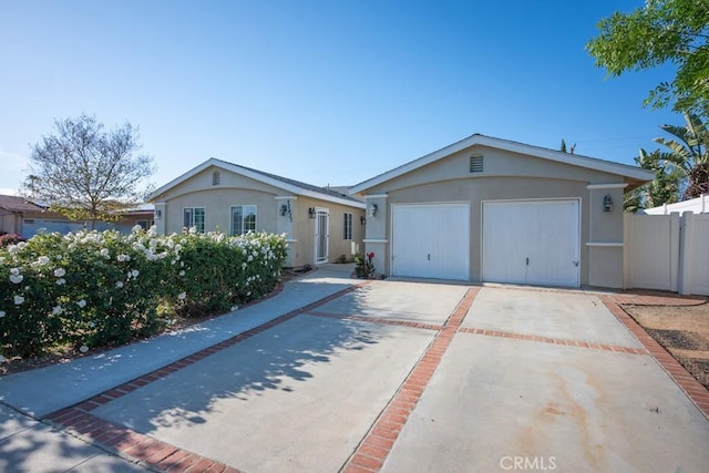 22437 Haynes St, West Hills, CA 91307 - ranch-style house with stucco siding, driveway, fence, and a garage