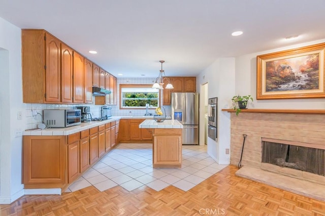 22437 Haynes St, West Hills, CA 91307 - kitchen featuring a center island, stainless steel appliances, tile counters, a warming drawer, and tasteful backsplash