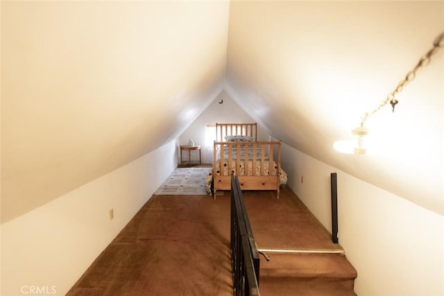 carpeted bedroom with lofted ceiling