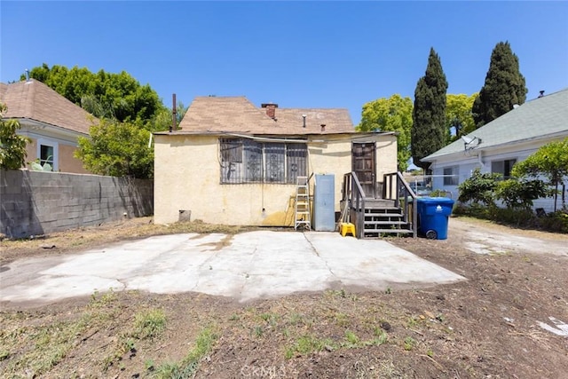 back of property featuring fence, a patio, and stucco siding