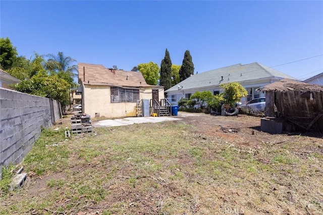 view of yard featuring fence and a patio area