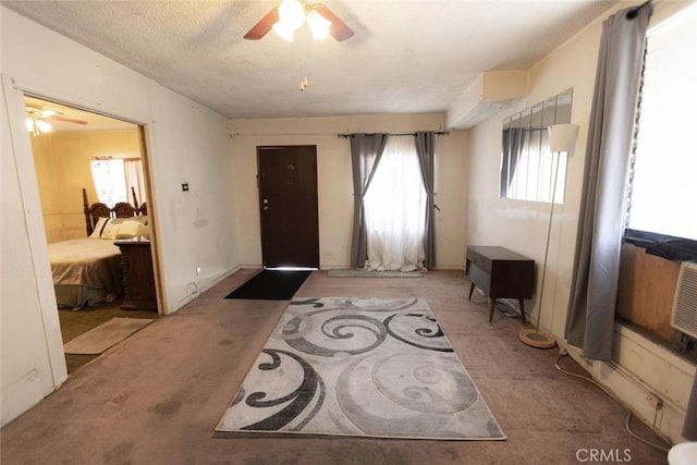 entryway featuring carpet floors and a ceiling fan