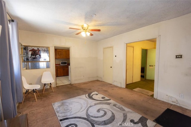 interior space featuring ceiling fan and light colored carpet