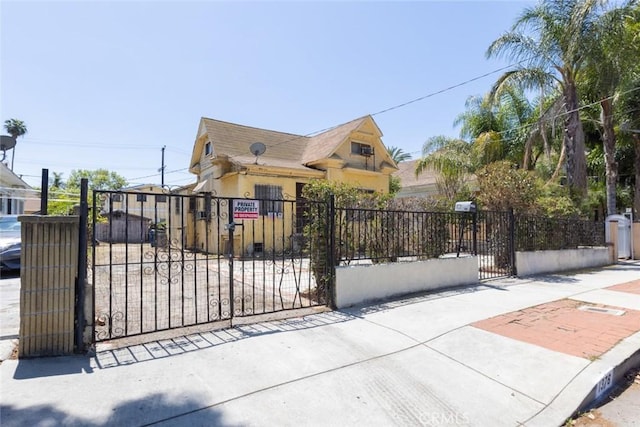 view of gate with a fenced front yard