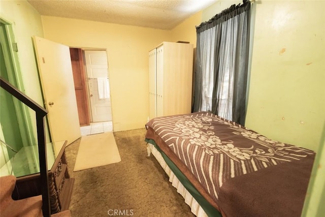 bedroom with carpet floors and a textured ceiling