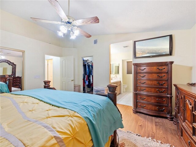 18668 Kamana Rd, Apple Valley, CA 92307 - bedroom with visible vents, a closet, lofted ceiling, light wood-style floors, and a walk in closet