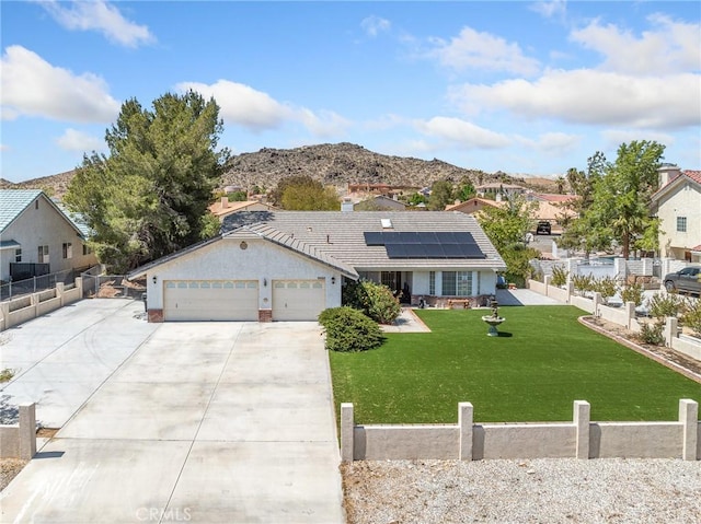 18668 Kamana Rd, Apple Valley, CA 92307 - ranch-style house featuring driveway, a front yard, fence, roof mounted solar panels, and an attached garage
