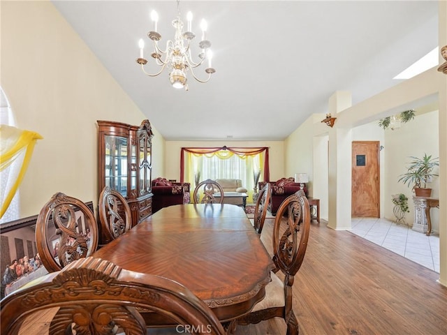 18668 Kamana Rd, Apple Valley, CA 92307 - dining space featuring light wood-type flooring, a chandelier, and vaulted ceiling