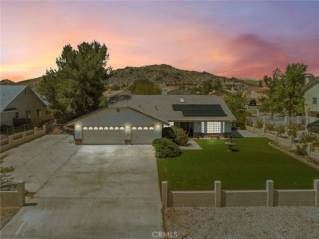 18668 Kamana Rd, Apple Valley, CA 92307 - ranch-style home with fence, concrete driveway, a yard, and solar panels