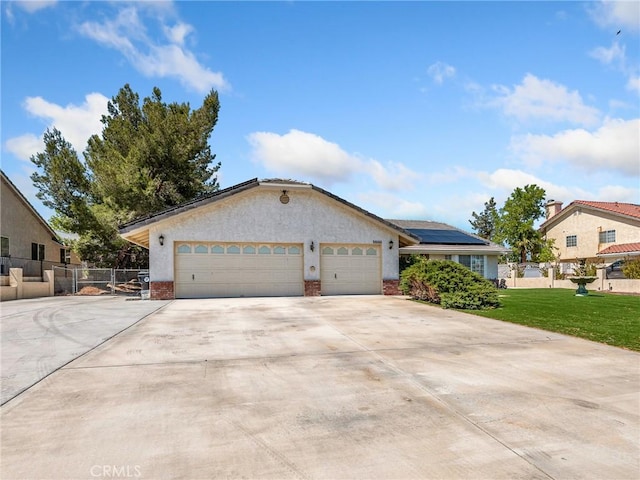 18668 Kamana Rd, Apple Valley, CA 92307 - ranch-style home with a garage, fence, a front yard, driveway, and solar panels