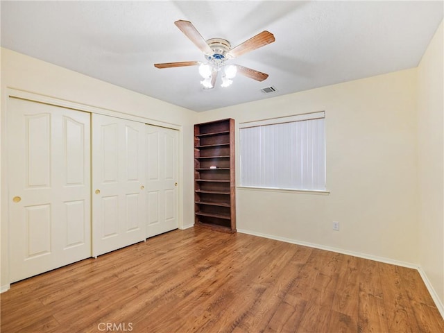 18668 Kamana Rd, Apple Valley, CA 92307 - unfurnished bedroom with light wood-style flooring, a ceiling fan, baseboards, visible vents, and a closet
