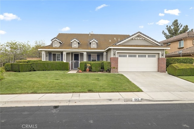 562 Silverhawk Dr, Corona, CA 92879 - traditional-style house with an attached garage, driveway, a front yard, brick siding, and a porch