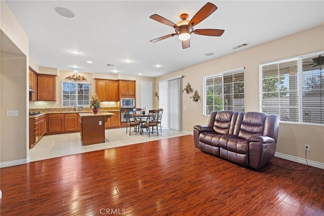 562 Silverhawk Dr, Corona, CA 92879 - living room featuring light wood-type flooring, a ceiling fan, baseboards, and recessed lighting