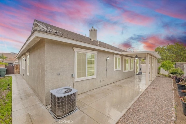 562 Silverhawk Dr, Corona, CA 92879 - back of house with central AC unit, a patio area, stucco siding, and a chimney