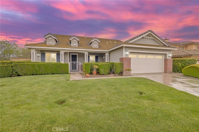 562 Silverhawk Dr, Corona, CA 92879 - view of front of home featuring concrete driveway, a garage, a front lawn, brick siding, and a porch