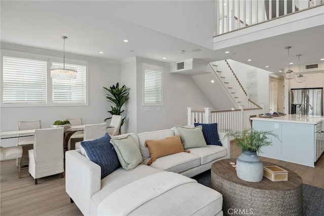 1524 Wollacott St, Redondo Beach, CA 90278 - living area with light wood finished floors, recessed lighting, stairs, a chandelier, and crown molding