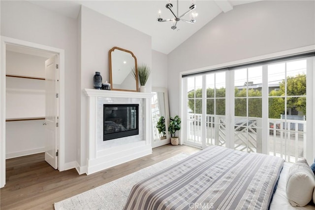 1524 Wollacott St, Redondo Beach, CA 90278 - bedroom with a chandelier, wood finished floors, high vaulted ceiling, baseboards, and access to outside