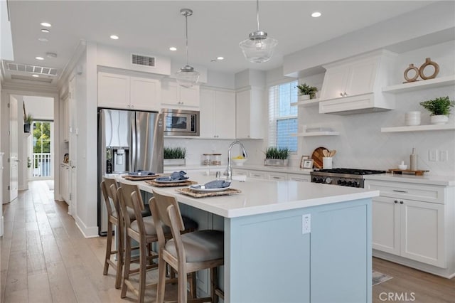 1524 Wollacott St, Redondo Beach, CA 90278 - kitchen featuring open shelves, appliances with stainless steel finishes, white cabinetry, recessed lighting, and an island with sink