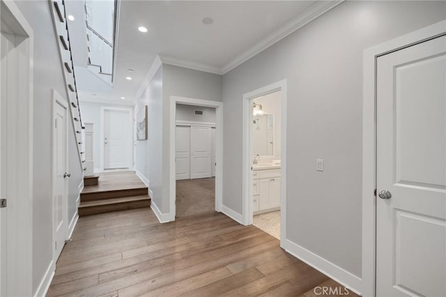 1524 Wollacott St, Redondo Beach, CA 90278 - hallway with crown molding, light wood finished floors, baseboards, a sink, and recessed lighting