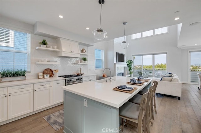 1524 Wollacott St, Redondo Beach, CA 90278 - kitchen featuring a sink, stainless steel stove, open floor plan, open shelves, and light wood finished floors