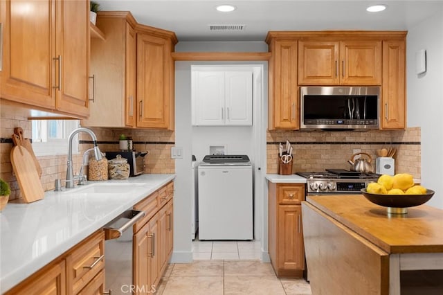 6582 Corrine Cir, Huntington Beach, CA 92647 - kitchen featuring visible vents, appliances with stainless steel finishes, tasteful backsplash, a sink, and recessed lighting