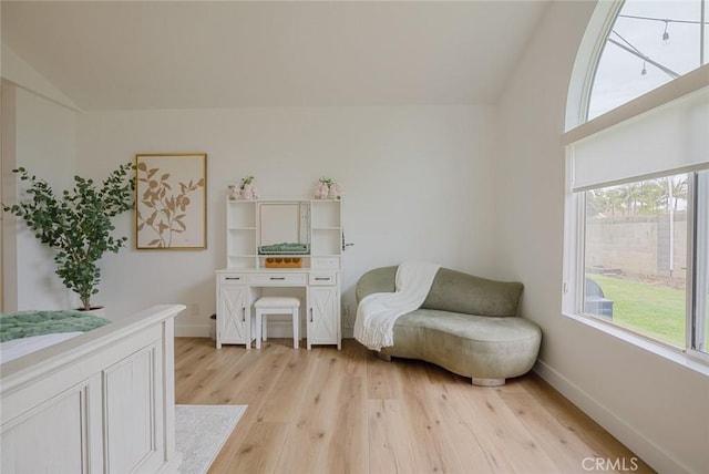 6582 Corrine Cir, Huntington Beach, CA 92647 - living area with baseboards, lofted ceiling, and light wood finished floors