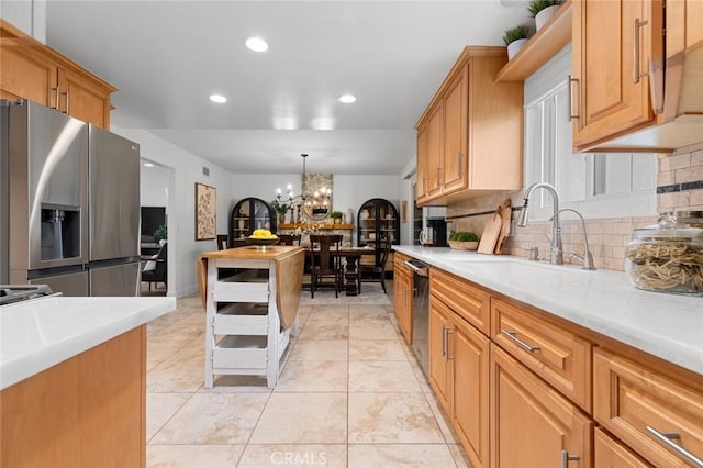 6582 Corrine Cir, Huntington Beach, CA 92647 - kitchen featuring a sink, light countertops, stainless steel appliances, recessed lighting, and backsplash