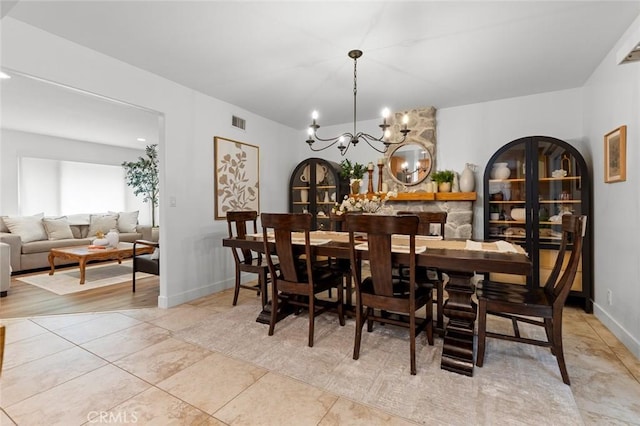 6582 Corrine Cir, Huntington Beach, CA 92647 - dining room with a chandelier, baseboards, visible vents, and light tile patterned floors