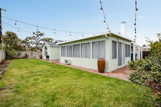 6582 Corrine Cir, Huntington Beach, CA 92647 - back of property featuring a patio, a fenced backyard, a chimney, a sunroom, and a lawn