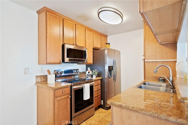 kitchen with light countertops, appliances with stainless steel finishes, and a sink