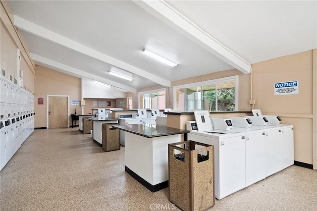 community laundry room with baseboards, independent washer and dryer, and stacked washer / dryer