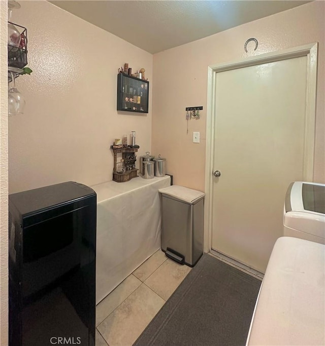 laundry area featuring laundry area, light tile patterned flooring, and independent washer and dryer