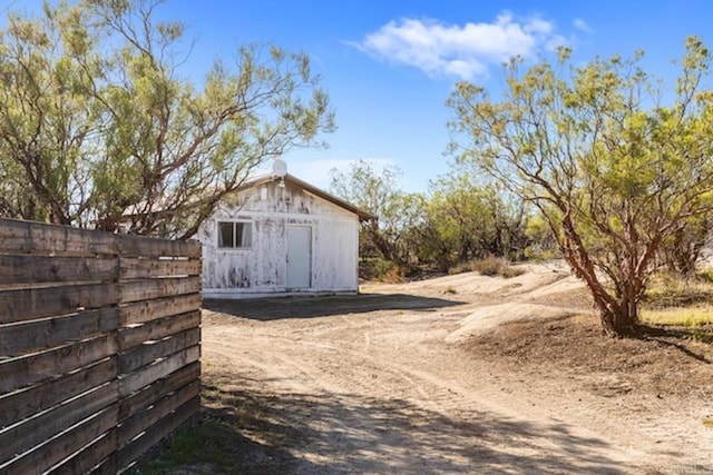 view of barn with fence