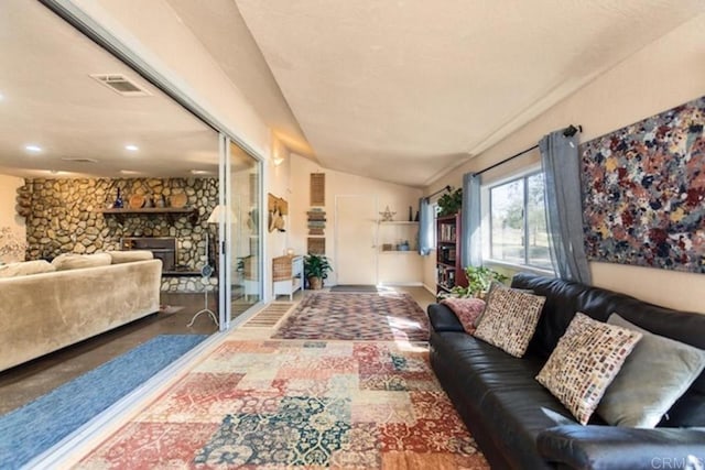 interior space with visible vents, recessed lighting, lofted ceiling, and a fireplace