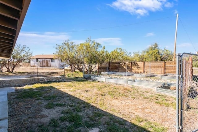 view of yard featuring fence and a garden
