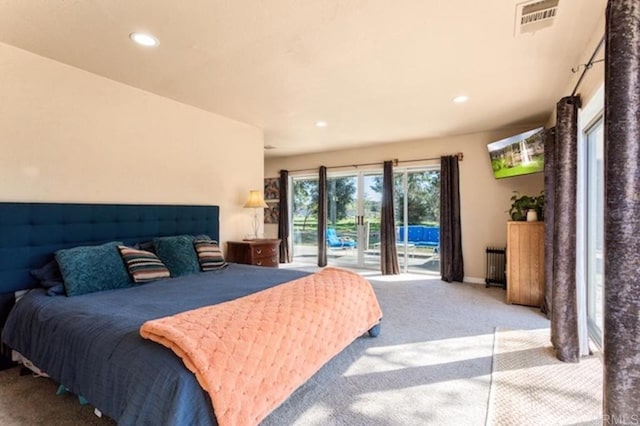 bedroom featuring carpet floors, access to exterior, radiator heating unit, recessed lighting, and visible vents