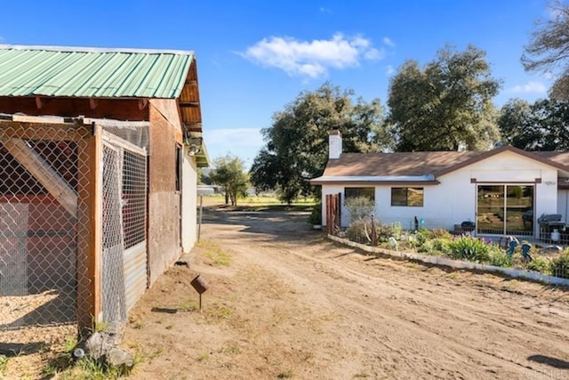 view of road featuring dirt driveway