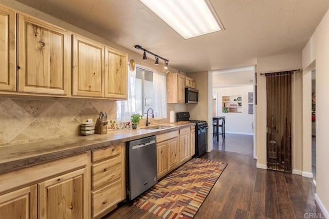 kitchen featuring a sink, appliances with stainless steel finishes, light brown cabinets, and dark wood-type flooring